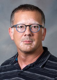 Headshot of Mark Enfield.